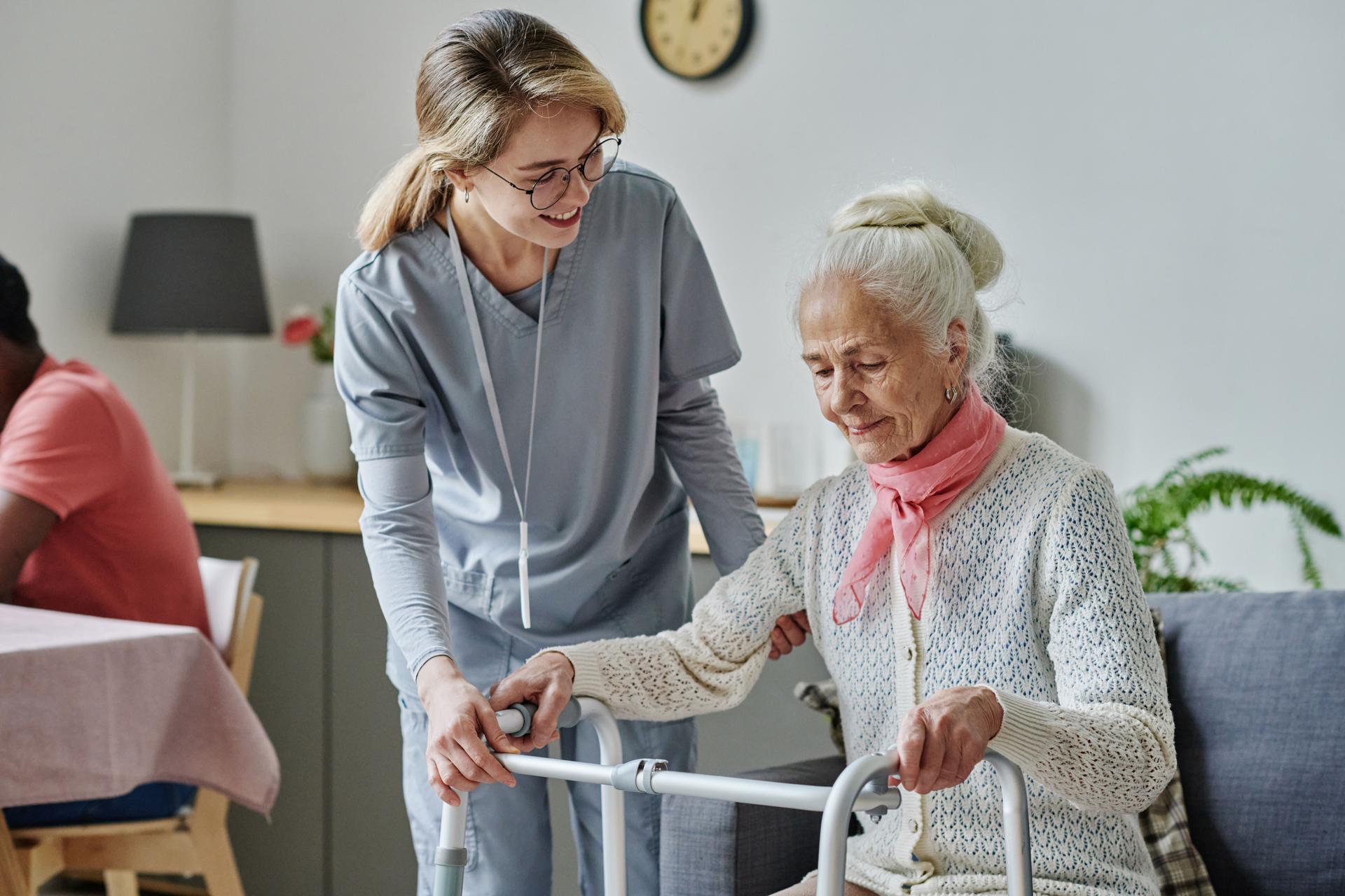 Young caregiver caring about senior woman